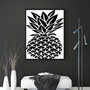 May include: A framed wall art print featuring a bold, high-contrast black and white graphic illustration of a pineapple. The artwork displays a stylized, geometric pattern for the fruit body and sharp, pointed leaves at the top, centered in a frame.