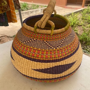 May include: A white ceramic mug with a black handle and the text "But First, Coffee" in a handwritten style. The mug is on a white surface. The mug is approximately 4 inches tall.