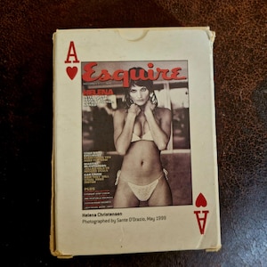 May include: A rectangular white playing card box featuring a reproduction of an Esquire magazine cover from May 1999. The cover displays a photograph of Helena Christensen in a white bikini, with the text Esquire, Helena, and other headlines.