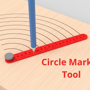 May include: A red plastic circle marker tool with a grey pivot point and numbered holes from 0.5 to 10. A blue pencil is inserted into the 3.5 hole, drawing a series of concentric black arcs on a light wood surface. Text reads Circle Marker Tool.