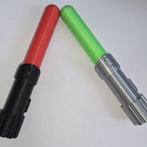 May include: Two toy lightsabers, one red and one green, with black and silver handles.