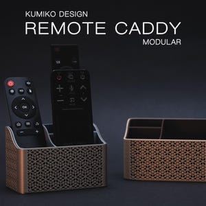 May include: Two modular remote caddy organizers featuring a copper-colored exterior with a geometric Kumiko-inspired lattice pattern. One caddy holds two black remote controls, while the other is empty, showing internal dividers and compartments.