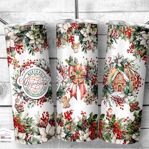 May include: White tumbler with a Christmas-themed design. The design includes gingerbread men, a gingerbread house, holly, poinsettias, and the text "North Pole Gingerbread Baking Co." The tumbler has a silver straw.