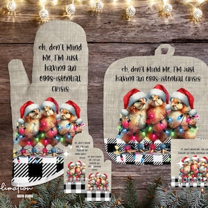 May include: A set of three oven mitts with a black and white checkered pattern. The mitts feature a festive design with three chicks wearing Santa hats and surrounded by Christmas lights. The text on the mitts reads "oh, don't mind me, I'm just having an eggs-istential crisis".