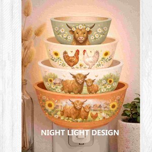May include: A stack of decorative night light bowls with farm animal designs. The bowls feature images of a cow, chickens, and Highland cattle. The bowls are in shades of orange, cream, and green. The text "NIGHT LIGHT DESIGN" is at the bottom.