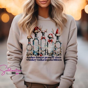 May include: A beige sweatshirt with a Christmas-themed design featuring five bottles of liquor wearing Santa hats and reindeer antlers. The text "dasher dancer prancer vixen whiskey vodka tequila blitzen" is printed below the bottles.