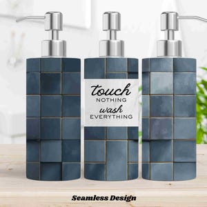 May include: Three dark blue soap dispensers with silver pumps. The dispensers have a square tile design with gold accents. The center dispenser has a white label with the text "touch nothing wash everything". The words "Seamless Design" are at the bottom.