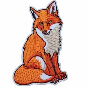 May include: An embroidered patch of a sitting fox with orange fur, a white chest, and a bushy tail.