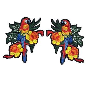 May include: Two embroidered iron-on patches featuring a parrot with red, orange, and blue feathers perched on a branch with yellow flowers. The parrot is surrounded by green leaves.