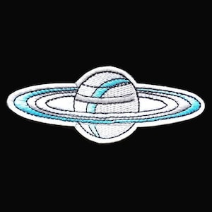 May include: White embroidered patch of a planet with rings. The planet is white with a blue ring around it. The rings are white with a blue outline.