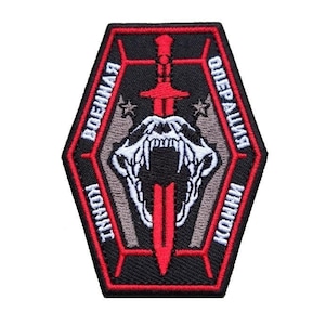 Puede incluir: Un parche bordado negro y rojo con una calavera blanca y una espada roja. El texto alrededor del borde dice "Военная Операция" y "Конвой".