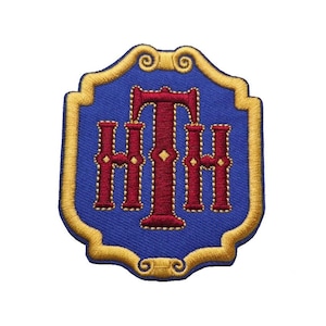 May include: A blue and gold embroidered patch with the letters "HHH" in red.