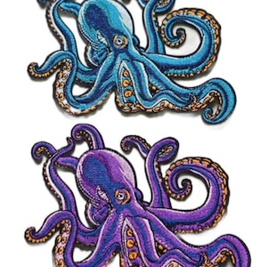 May include: Two embroidered octopus patches. One is blue with orange accents, the other is purple with orange accents. Both have detailed stitching and are on a white background. The octopus patches are likely for clothing or accessories.