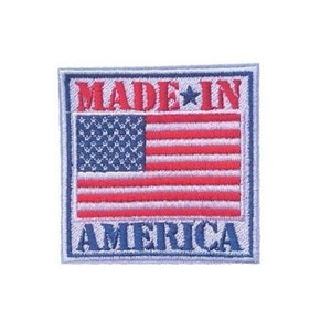 May include: Embroidered patch with a white background, blue border, and red, white, and blue American flag. The text "MADE IN AMERICA" is in blue and red lettering.