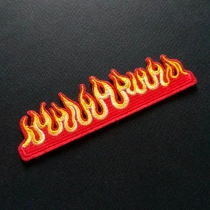 May include: Embroidered red patch with yellow and orange flames. The word "BURNS" is written in a flame-like font. The patch is rectangular and has a black background.