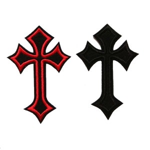 May include: Two iron-on patches in the shape of a cross. One cross is black with a red outline, and the other is black. Both crosses have a pointed design.
