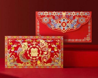 May include: Two red envelopes with intricate gold, blue, and yellow designs. One envelope features a phoenix and dragon with Chinese characters. The other has a floral pattern and Chinese characters. Both are on a red background.
