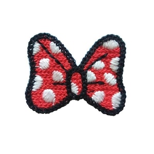 May include: Red and white polka dot bow with black outline.