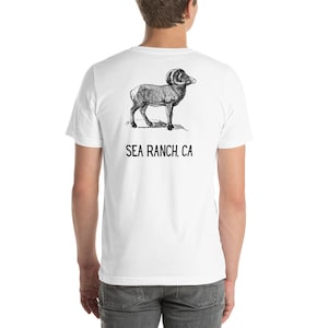 May include: White t-shirt with a black and white illustration of a bighorn sheep on the back. The text "SEA RANCH, CA" is printed below the illustration.