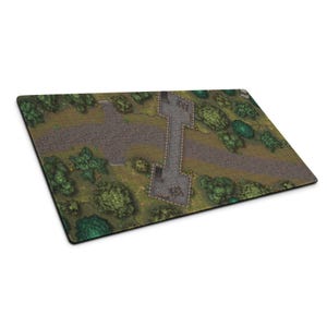 May include: A rectangular gaming mat with a detailed fantasy landscape design. It features a stone bridge, pathways, trees, and a grid overlay. The colour scheme includes greens, browns, and greys, creating a realistic terrain.