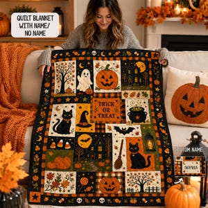 May include: A rectangular Halloween-themed quilt blanket featuring a patchwork design of pumpkins, black cats, ghosts, haunted houses, bats, and a cauldron. The center panel displays the text TRICK OR TREAT, and a small label shows the name SOPHIA.