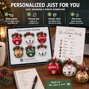 May include: A digital tablet displaying a custom preview of six personalized Christmas jingle bell ornaments with names and icons, alongside three physical jingle bell ornaments in red, white, and gold, each topped with a pinecone and plaid ribbon.