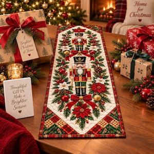 May include: A rectangular quilted table runner featuring two nutcracker figures, red poinsettias, green pine branches, and pinecones. The border displays a red and green plaid pattern. The runner is surrounded by wrapped gifts and holiday decor.