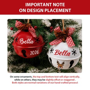 May include: Two round metal jingle bell ornaments, one red and one white, each featuring the name Bella, snowflake graphics, and the year 2026. They are topped with red and white gingham bows, pine needles, and small pinecones for decoration.