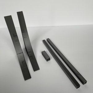 May include: A set of five 3D printed pieces in gray plastic. The set includes two curved pieces, two long straight pieces, and one small square piece.
