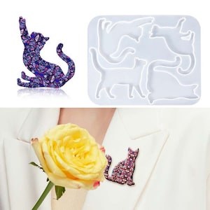 May include: A white silicone mold with five cat shapes. The mold is used to create resin cat ornaments. A purple and pink cat ornament is shown next to the mold.
