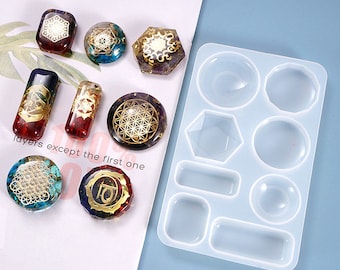May include: A clear silicone mold with 10 different shapes for resin casting. The mold is designed to create round, oval, rectangular, and hexagonal shapes. The mold is shown with various resin castings in different colors and patterns.