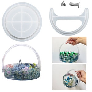 May include: A clear resin tray with a handle, divided into four sections. The tray is filled with dried flowers and greenery. The tray is made with a silicone mold and is perfect for creating unique resin crafts.