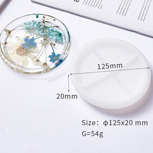 May include: White silicone mold for resin casting, measuring 12.5 inches in diameter and 2 inches in height. The mold is divided into four sections. Size:  &Phi;125x20 mm G=54g