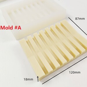 Op de afbeelding: Een beige siliconen mal met 10 rechthoekige sleuven. De mal is gemarkeerd met "Mold #A" en meet 120 mm bij 87 mm bij 18 mm.