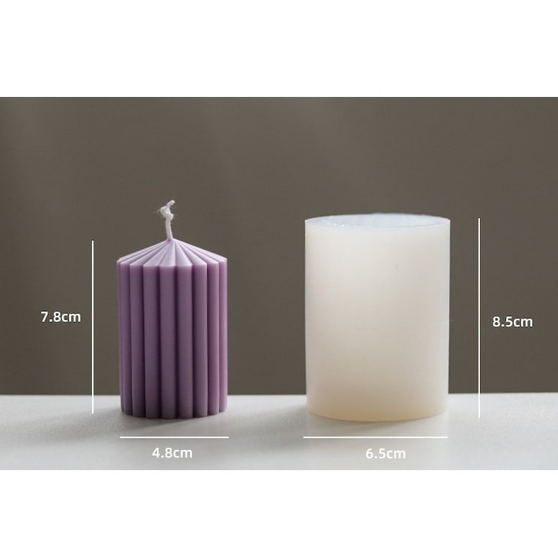 May include: Two candles, one purple and one white, with measurements in inches. The purple candle is 3.1 inches tall and 1.9 inches wide. The white candle is 3.3 inches tall and 2.6 inches wide.