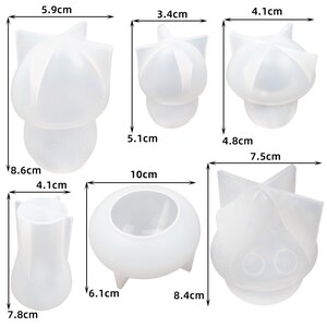 May include: Four clear silicone molds for making candles. The molds are shaped like a mushroom, a star, a flower, and a vase. The molds are 3.4 cm, 4.1 cm, 5.1 cm, 5.9 cm, 6.1 cm, 7.5 cm, 7.8 cm, 8.4 cm, 8.6 cm, and 10 cm in size.