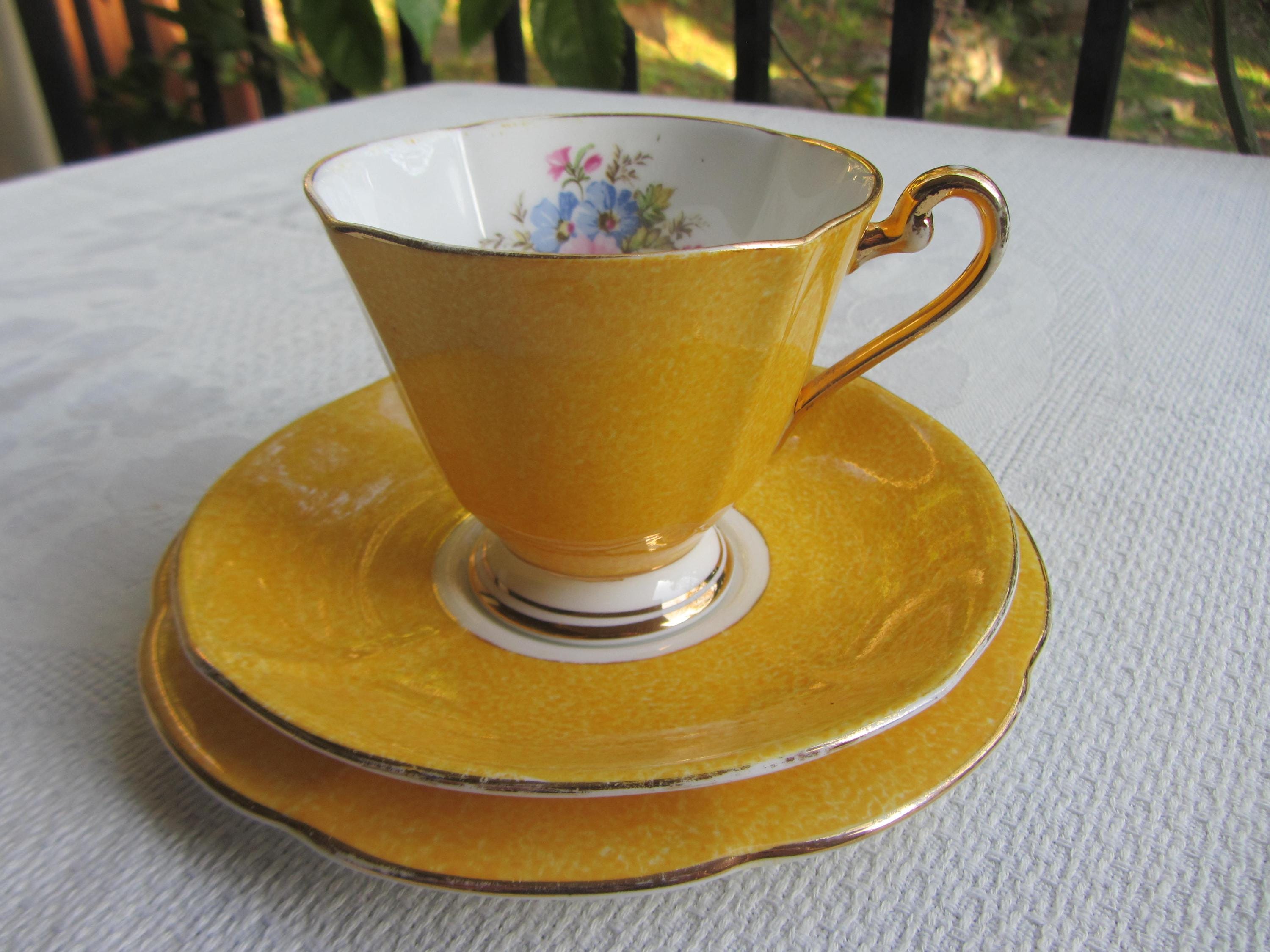 Roslyn China tea cup trio in yellow. English bone china cup, saucer and plate set, flowers to interior and gilding.   Ref AL