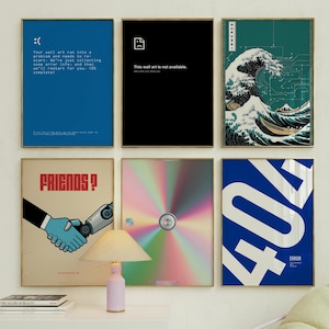 May include: A set of six framed wall art prints with various designs. The prints include a blue screen with an error message, a black screen with a file icon and the text "This wall art is not available", a blue and green print of a wave with the text "HOKUSAI", a print with a robot and a human hand shaking, a print with a rainbow gradient and a circle in the center, and a blue print with the number 404 and the text "ERROR".