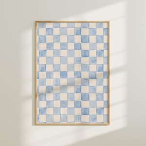 Puede incluir: Una impresión enmarcada de un patrón de cuadros azules y blancos. La impresión tiene un fondo azul claro con cuadrados blancos y un borde blanco.