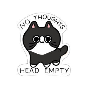 May include: A black and white cat with large eyes and a cute expression. The cat is surrounded by a white circle with the text "NO THOUGHTS HEAD EMPTY".