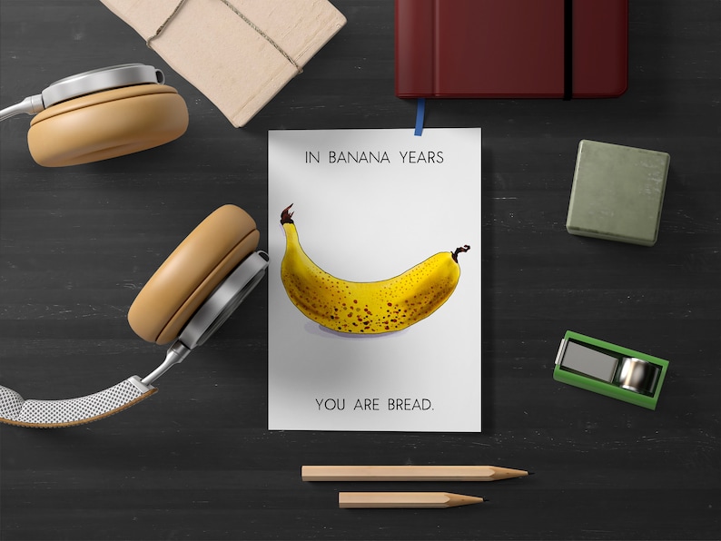 May include: A white card with the text "In banana years, you are bread." and a drawing of a yellow banana with brown spots.