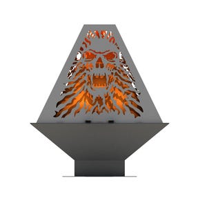 May include: A metal fire pit shaped like a pyramid with a skull design cut out. The fire pit is lit and the flames are visible through the skull design.