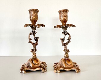 A pair of Vintage French candlesticks, Victorian style. Adorned as a flower with leaves and a whimsical curled stem.