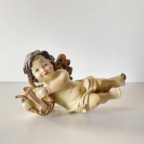 Vintage Putti Cherub figurine with instrument, handpainted and gilded.