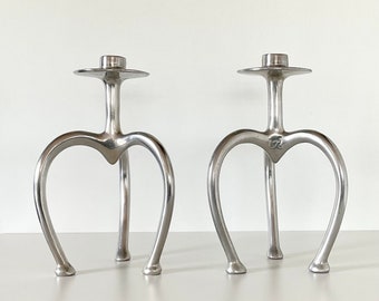 STEPHANE RONDEL - A pair of aluminium modernist candlestick holders by French/New Zealand artist Stephane Rondel, 1991.