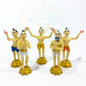 May include: Five hand-painted figurines of male figures in various poses. The figures have light skin, black hair, and are wearing shorts in blue, yellow, and orange. Each figure stands on a gold-colored lotus flower base.