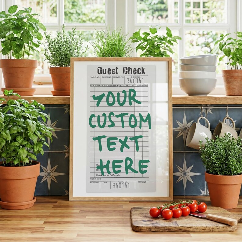 May include: A framed vertical print featuring a vintage-style guest check design with a light gray background and dark grid lines. The text 'Guest Check' appears at the top, with 'YOUR CUSTOM TEXT HERE' printed in large, bold green letters.