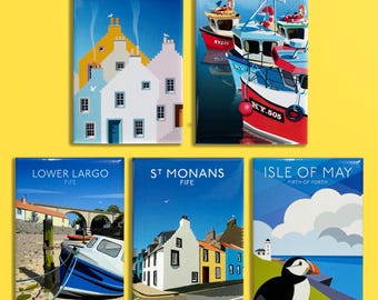 May include: A set of five rectangular magnets featuring colorful illustrations of Scottish coastal scenes. The designs include white and yellow houses, fishing boats in a harbor, the Lower Largo viaduct, St Monans buildings, and a puffin on the Isle of May.
