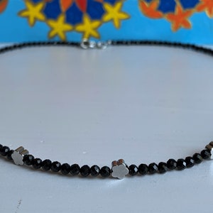 black spinel, delicate necklace of 3 mm pearls with glittering facets and small delicate flowers
