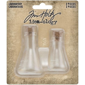 May include: Two clear glass laboratory bottles with cork stoppers. The bottles are in a plastic package with the words "Laboratory" and "Idea-ology" printed on the packaging.